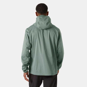 Back view of a man wearing a sage green Helly Hansen hooded rain jacket