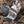 Glacier Glove camouflage hunting gloves with black palms on dry foliage