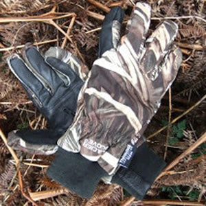 Glacier Glove camouflage hunting gloves with black palms on dry foliage