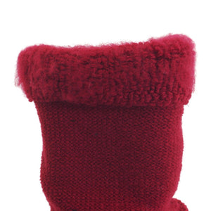 Close up of a red knitted wool sock cuff