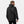 Man wearing a black Helly Hansen hooded rain jacket from the back