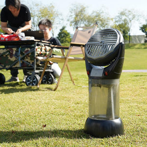 Portable misting fan on grass with people in background