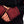 Close up of black long sleeve shirt with red gradient cuffs and red stitching