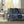 Navy blue and white lattice patterned electric throw blanket draped over a grey sofa