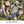 Two people wearing Mission hats and cooling gear while gardening outdoors