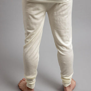 Back view of Merino Skins cream merino wool thermal leggings on a person