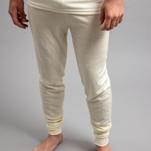 Merino Skins cream thermal leggings worn by a person