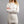 Woman wearing a white long sleeve Merino Skins base layer top
