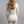 Back view of a woman wearing a cream Merino Skins long sleeve thermal top