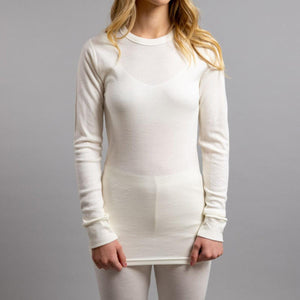 Woman wearing a Merino Skins cream long sleeve crew neck thermal top