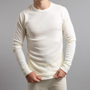 Man wearing a cream Merino Skins long sleeve thermal shirt