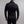 Back view of a man wearing a black Merino Skins long sleeve base layer top