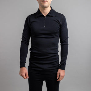 Man wearing a black Merino Skins long sleeve zip neck thermal top