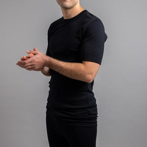 Man wearing a black Merino Skins short sleeve crew neck base layer top
