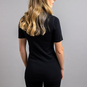 Back view of a woman wearing a black Merino Skins short sleeve shirt
