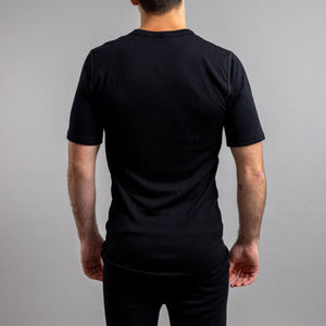 Back view of a man wearing a black Merino Skins short sleeve crew neck t-shirt