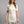 Woman wearing a cream Merino Skins short sleeve crew neck base layer top