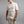 Man wearing a cream Merino Skins short sleeve thermal base layer top