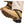 Tan work boots with black rubber ice cleats attached to the soles