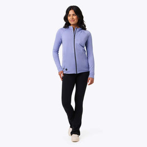 Woman wearing a purple Mobile Warming zip up hooded jacket and black pants