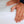 Hands pressing down on a white Outlast mattress protector
