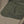 Close up of FjallRaven garment showing textured olive green pocket overlay on tan fabric