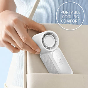 AlphaCool white portable handheld fan being placed into a bag pocket