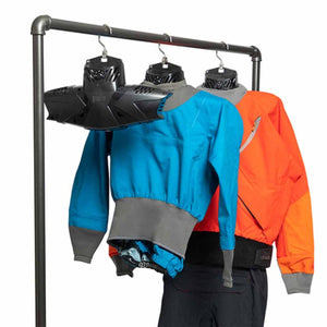 Three drysuits hanging on a metal rack with specialized drying hangers