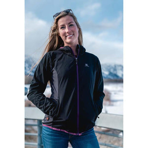 Woman wearing a black Fieldsheer hooded jacket with purple zipper accents outdoors