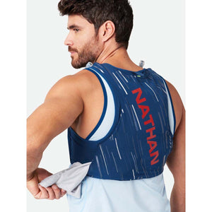Man wearing a blue Nathan hydration vest with white pattern