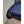 Black portable bed cooling unit with flexible air hose directed onto a blue bedspread