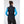Back view of a woman wearing a black Helly Hansen vest over a blue long sleeve shirt