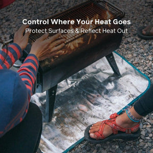 BioLite heat shield mat placed under a portable fire pit on gravel