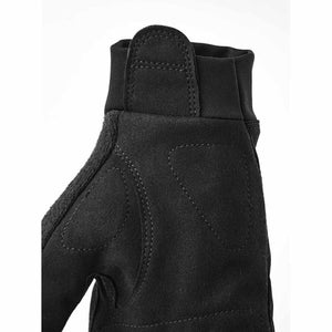 Close up of black tactical glove showing reinforced palm padding and elastic wrist cuff