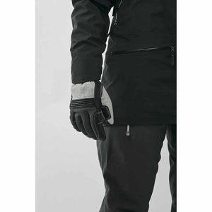 Hestra grey and black technical glove worn with black outdoor jacket