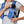 Person placing a smartphone into the Nathan hydration vest front pocket