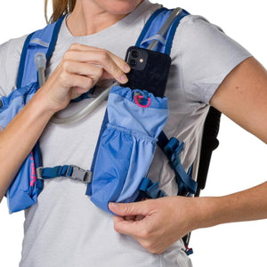 Person placing a smartphone into the Nathan hydration vest front pocket