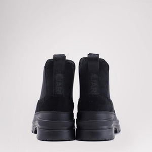 Back view of black Pajar Chelsea boots with thick rubber soles