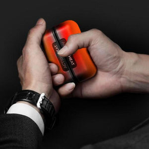 Person holding an orange and black ActionHeat portable hand warmer