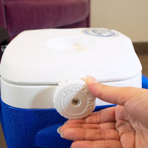Hand turning the white locking knob on a Polar Products cooler lid