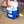Person placing water bottles into a blue Polar Products cold therapy cooler