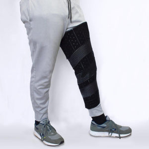Polar Products black leg compression wrap on a person wearing grey sweatpants