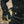 Person wearing black and yellow Therm-ic heated cycling gloves while holding handlebars