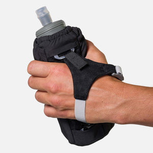 Hand holding a black handheld water bottle with an adjustable strap