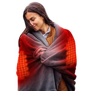 Woman wrapped in a heated blanket with visible glowing heating elements