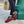Acorn burgundy slippers with faux fur lining worn with black pants