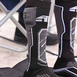 Black and grey heated socks with power button on the side