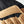 Hestra glove detail showing tan suede palm and black fabric back with embossed brand logo