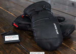 Seirus HeatTouch Hellfire heated mittens and battery pack on a wooden surface