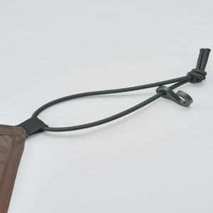 Brown fabric corner with black elastic cord and plastic tension hook